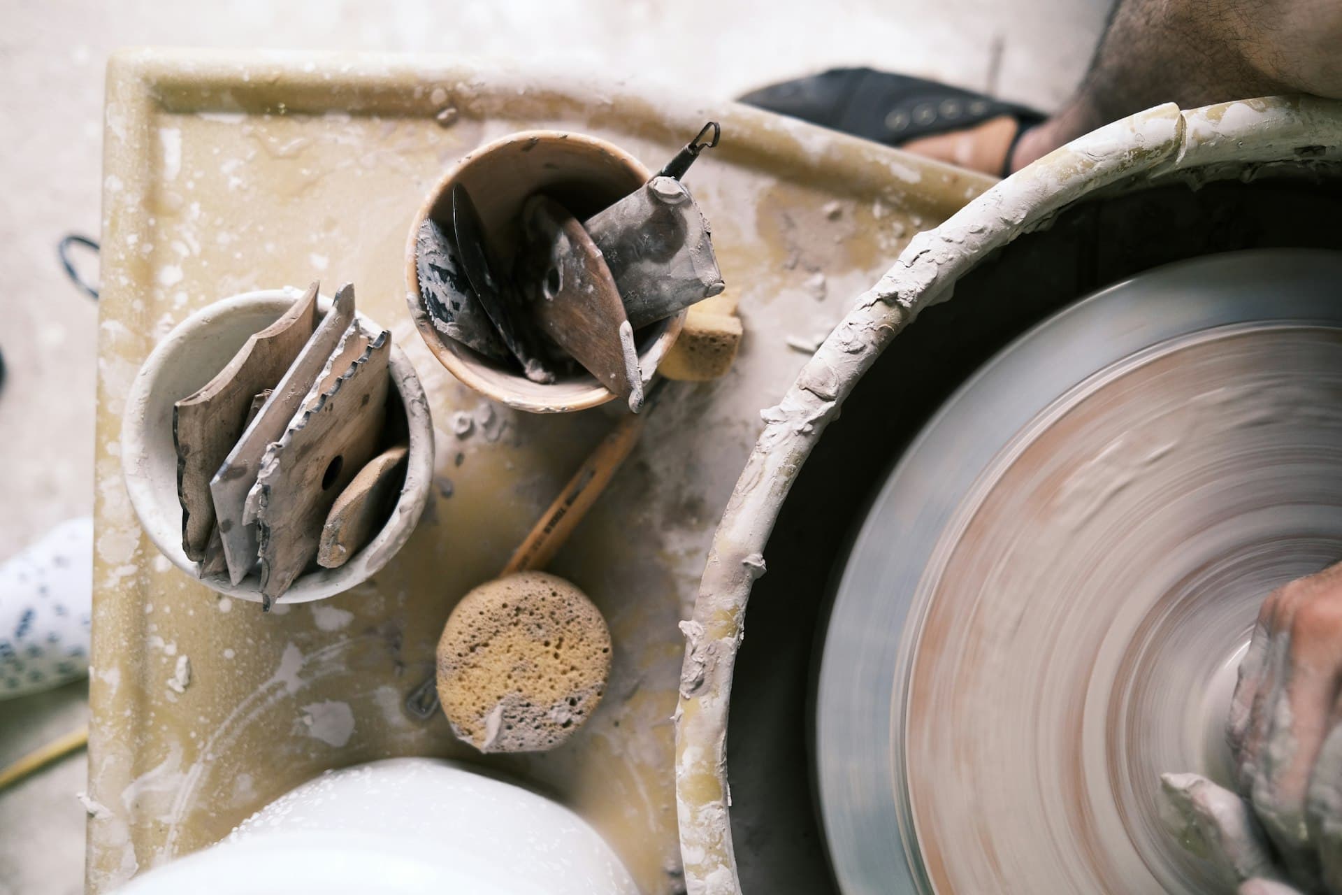 A pottery wheel and clay tools seen from above